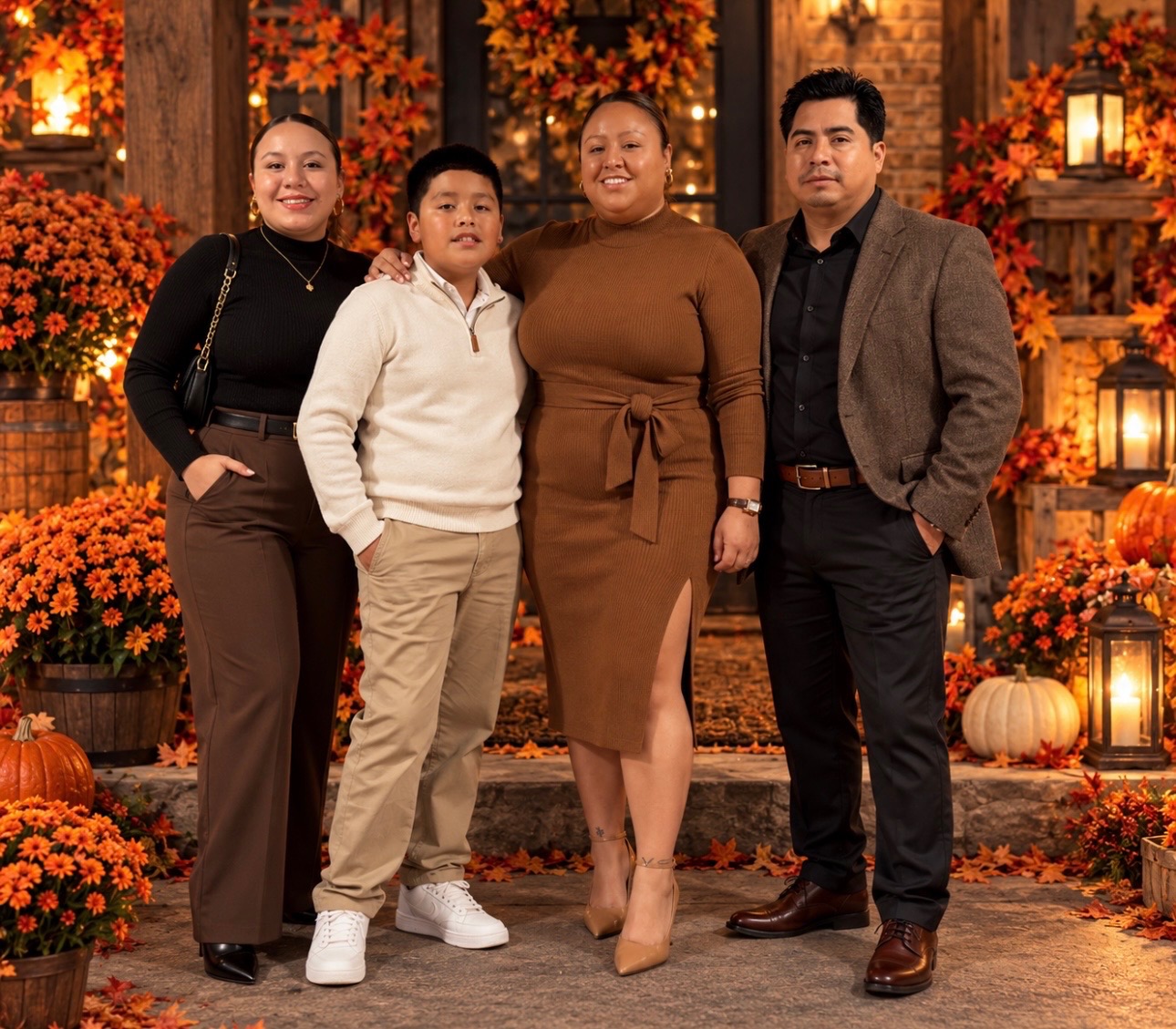 Andrea Ramirez's husband and children, four people gathered together before an autumn seasonal display.