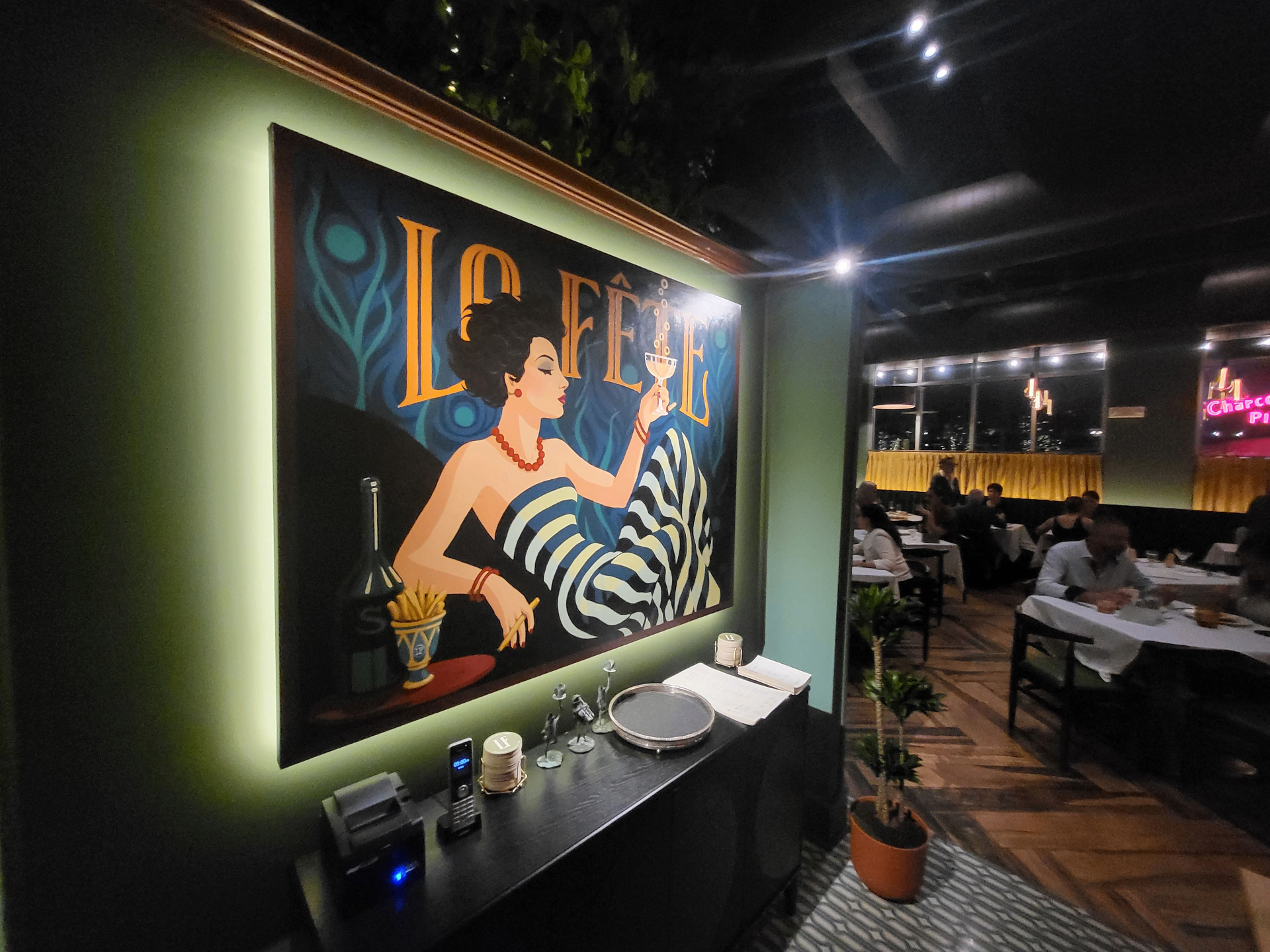 A dramatic close view of La Fête's glowing bar and richly lit dining atmosphere