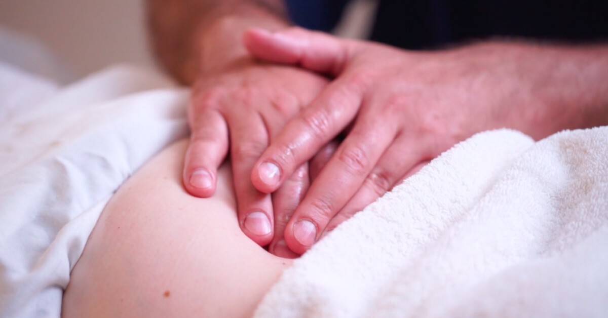 Manual therapy at DelCollo Acupuncture, a practitioner working with soft tissue by hand.