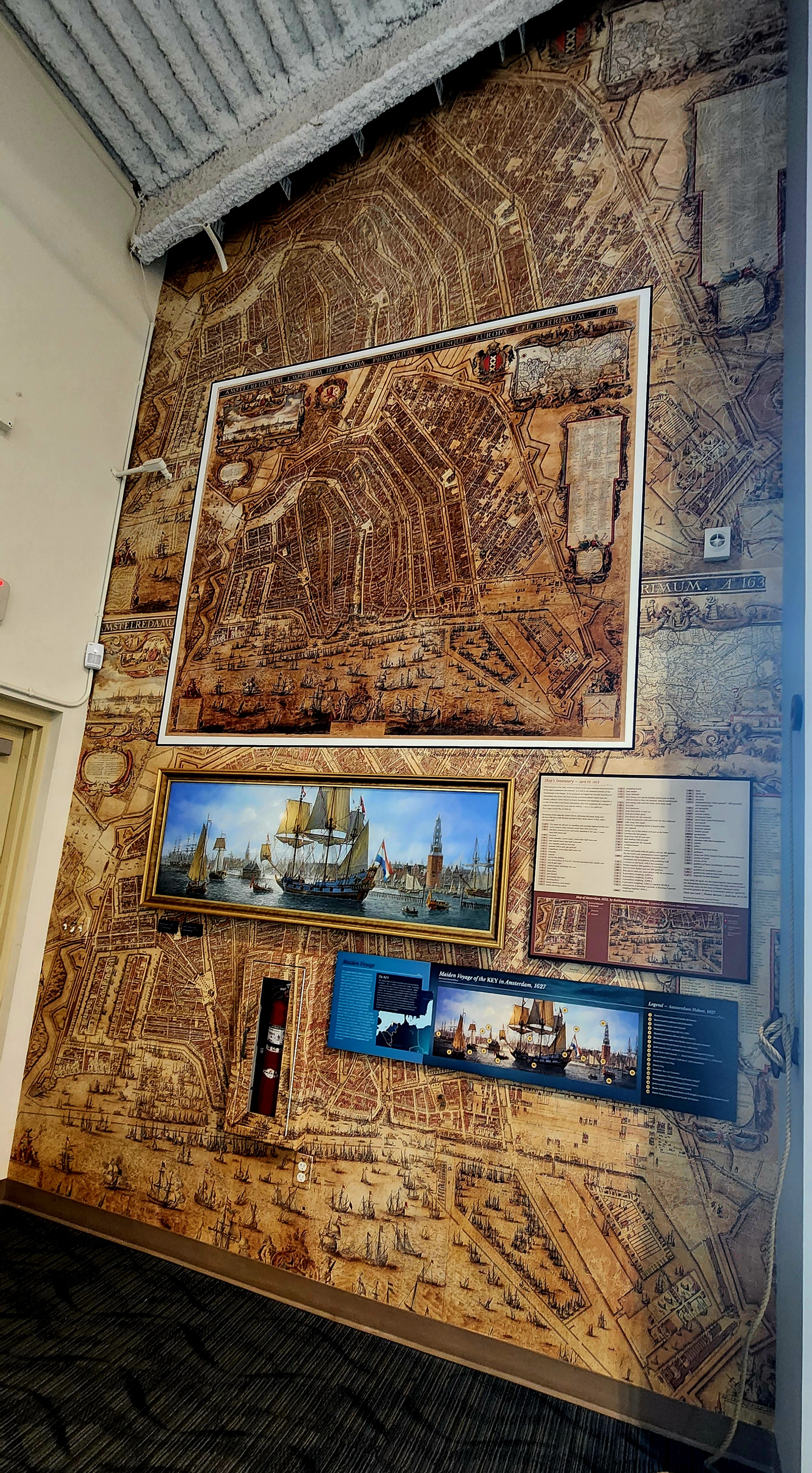 Historic Amsterdam map mural and framed ship painting inside the Copeland Maritime Center